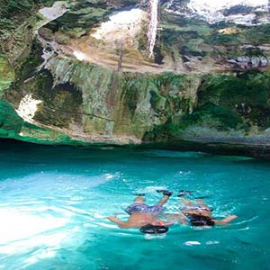 Couple snorkeling in Thunderball grotto